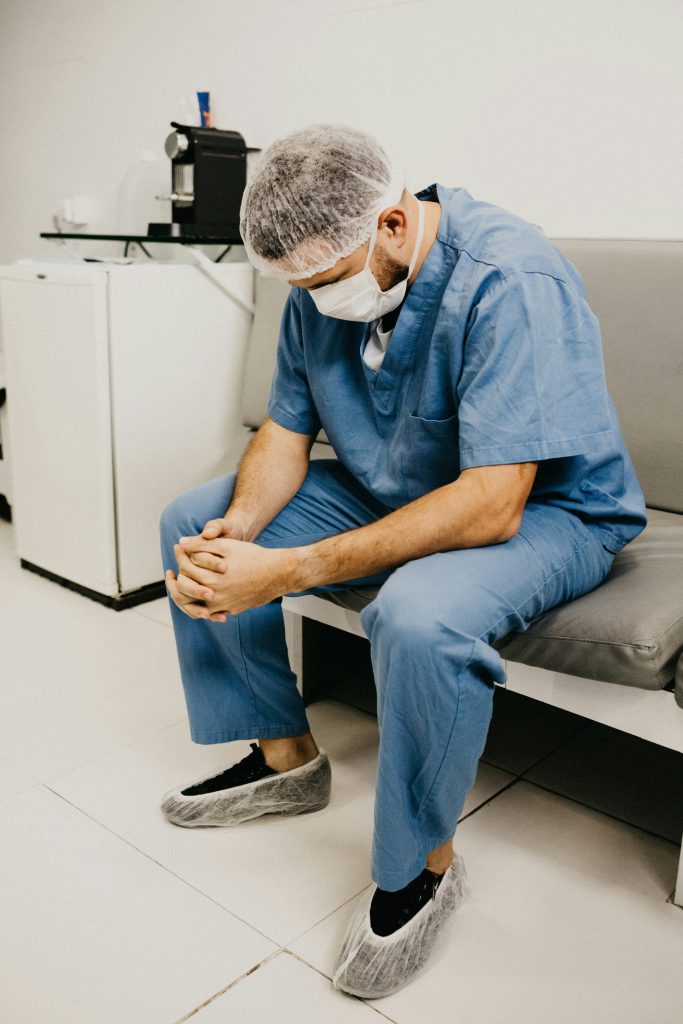 Physician practicing breathing exercise for nervous system stress recovery, stress recovery for doctors