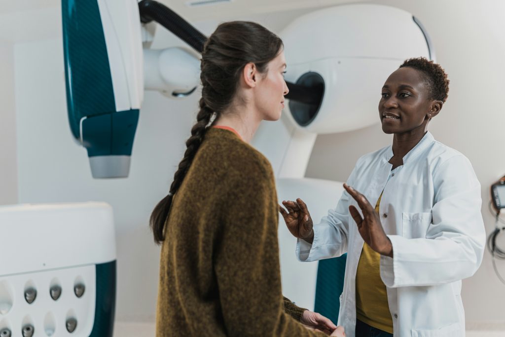 doctor calmly communicating with patient during tense interaction — de-escalation in healthcare