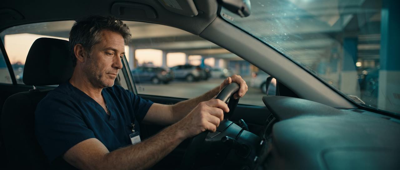 Physician sitting in his car before a shift